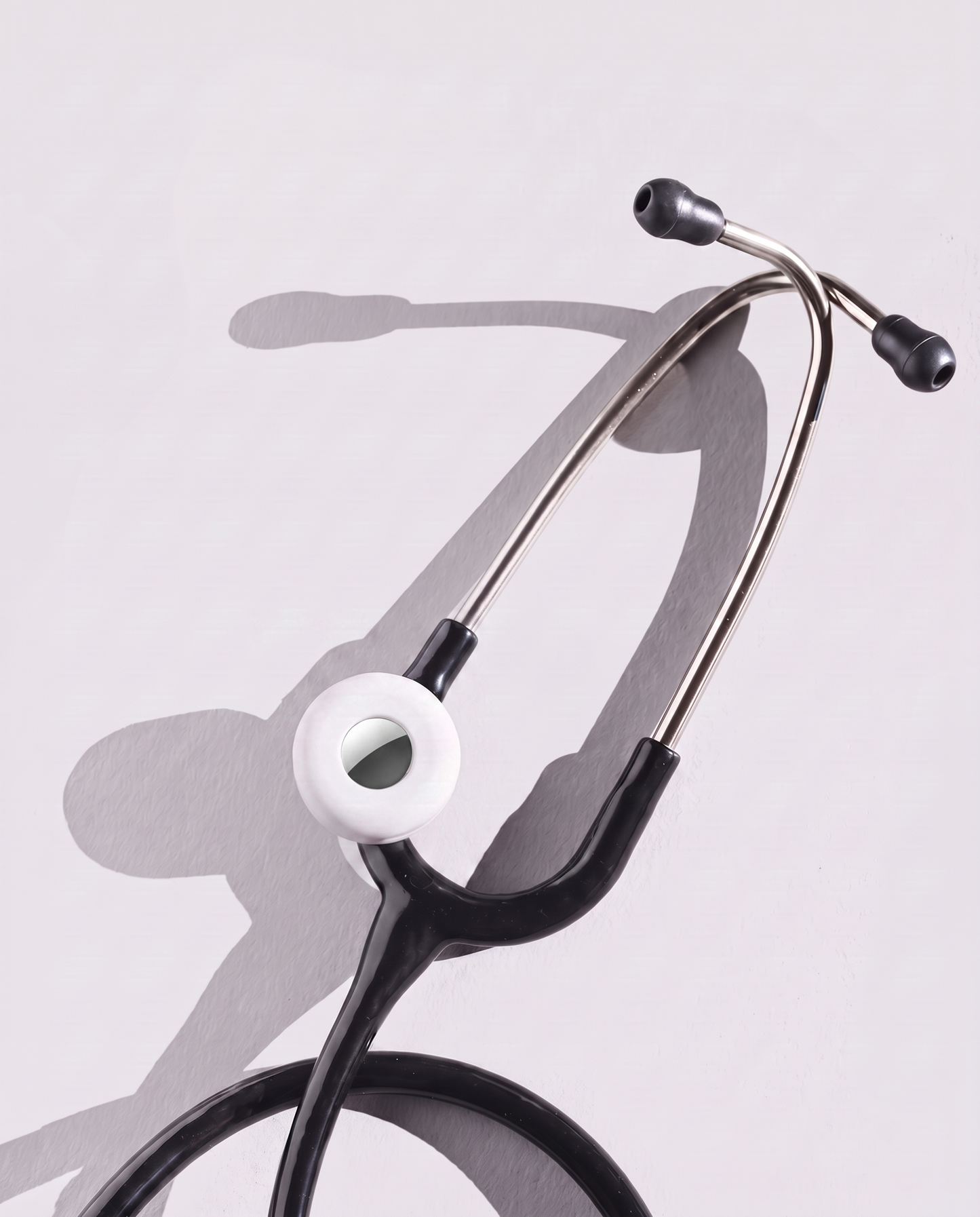 MotivatEM Stethoscope AirTag Holder in White on a black Littmann stethoscope