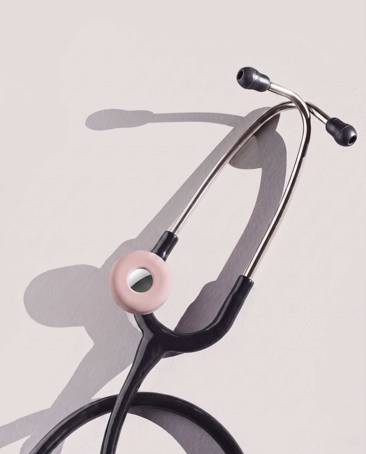 MotivatEM Stethoscope AirTag Holder in Blush Pink on a black Littmann stethoscope